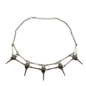Silver coloured necklace with five raven skull connected with silver metal pieces resembling bones.