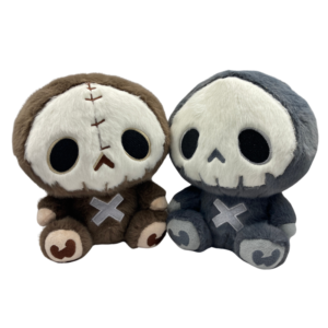 Cute gothic skeleton plushie sitting upright, featuring a soft embroidered skull face and stitched details, available in dark grey and earthy brown versions
