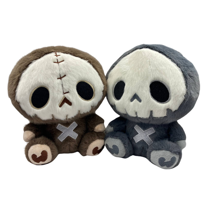 Cute gothic skeleton plushie sitting upright, featuring a soft embroidered skull face and stitched details, available in dark grey and earthy brown versions